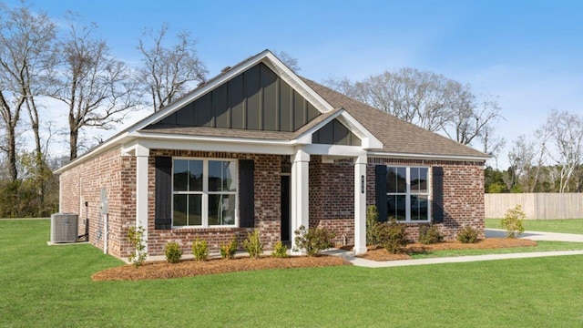 600 Golden Oaks Cir, Rehobeth, AL 36301 - view of front facade with fence, central AC, brick siding, a front lawn, and board and batten siding