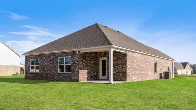 600 Golden Oaks Cir, Rehobeth, AL 36301 - back of house with brick siding, central air condition unit, a patio, and a lawn