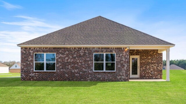 600 Golden Oaks Cir, Rehobeth, AL 36301 - rear view of property with a lawn, brick siding, and roof with shingles