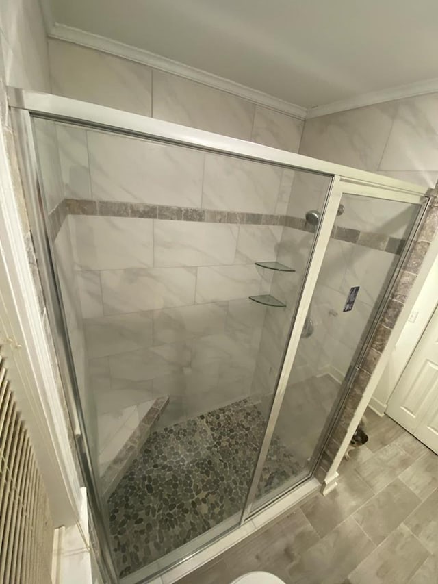 full bathroom with a shower stall and ornamental molding