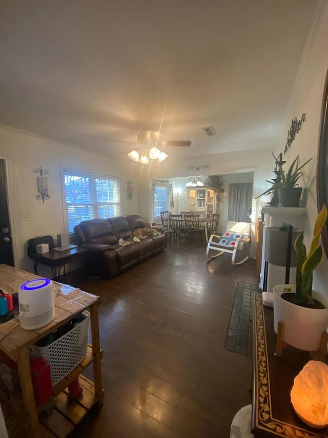 living area with visible vents and wood finished floors