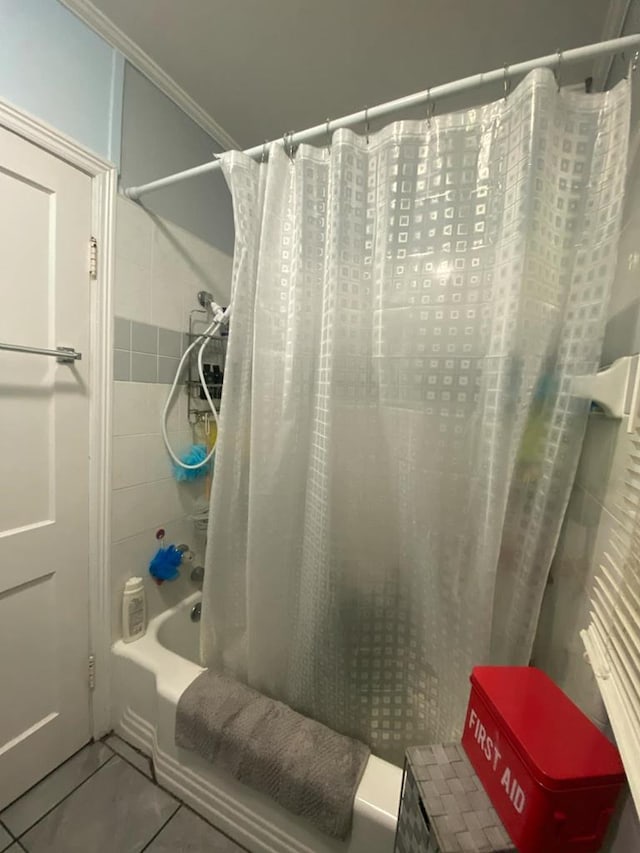 full bathroom with tile patterned floors, shower / tub combo with curtain, and ornamental molding