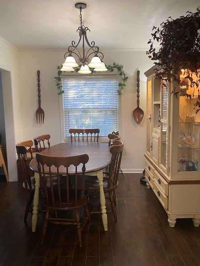 dining room with crown molding, baseboards, and wood finished floors