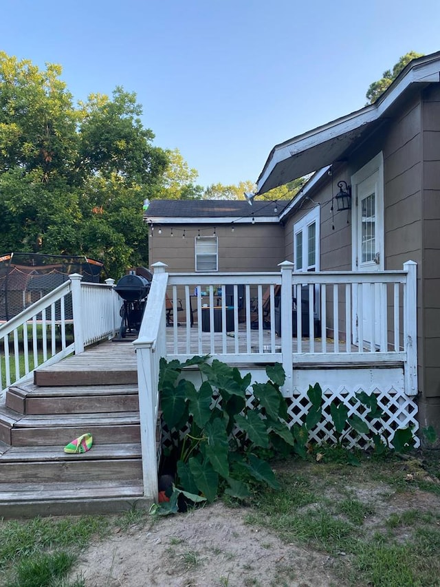 wooden deck with a grill