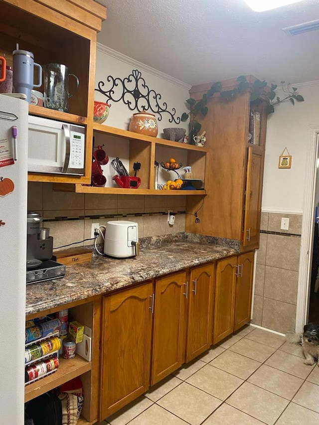 kitchen with brown cabinetry, ornamental molding, white appliances, and open shelves