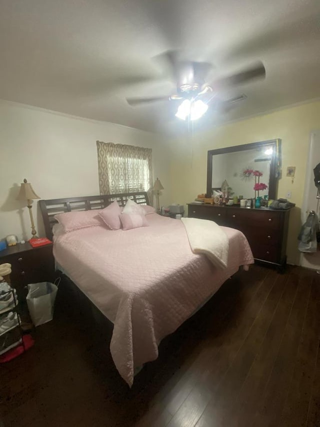 bedroom with ceiling fan and hardwood / wood-style flooring