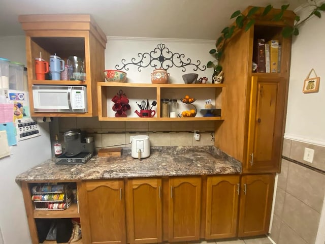 bar featuring tile walls and crown molding