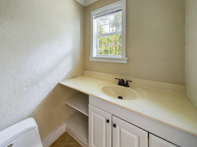 bathroom featuring tile patterned flooring, vanity, and toilet