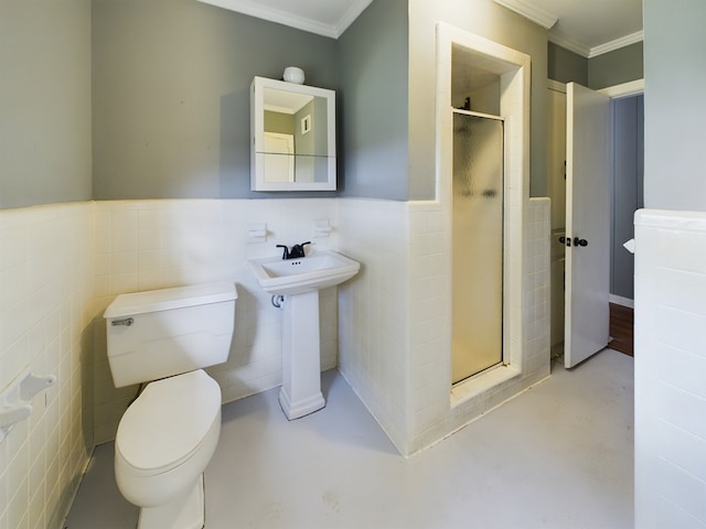 bathroom with concrete floors, a shower with door, tile walls, and ornamental molding