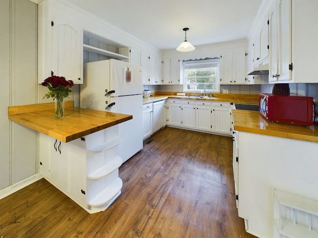 kitchen with white cabinets, white appliances, decorative light fixtures, and butcher block counters