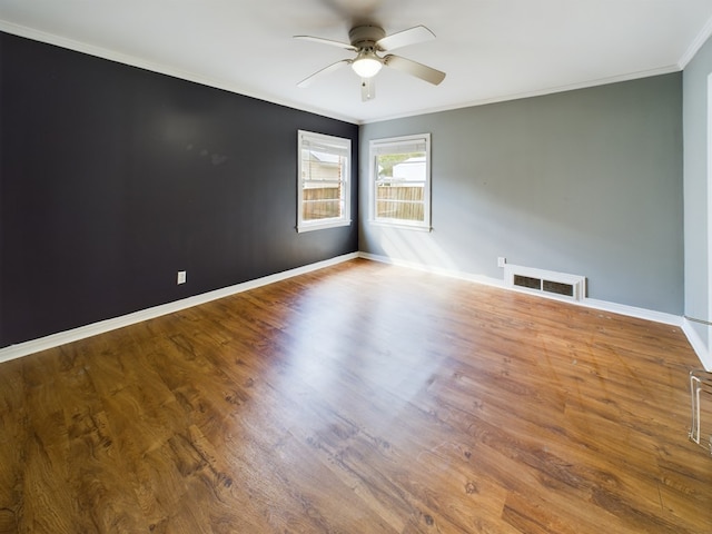 empty room with wood-type flooring, ceiling fan, and ornamental molding