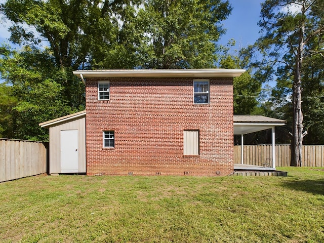 view of side of property featuring a lawn and a shed