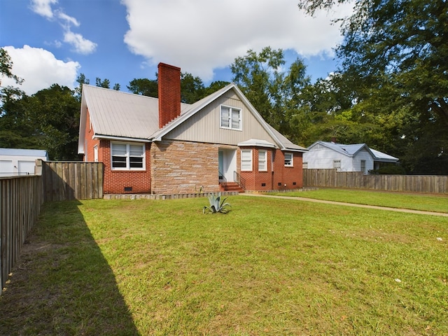 back of house with a lawn