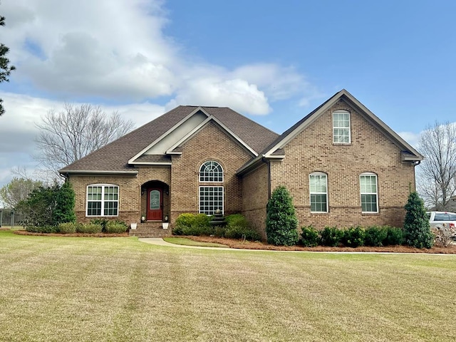 view of front of property with brick siding and a front lawn