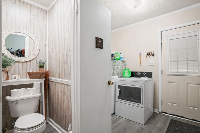 568 N Morris St, Slocomb, AL 36375 - laundry area featuring washer / clothes dryer, wood finished floors, crown molding, wooden walls, and a textured ceiling