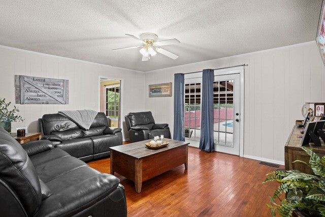568 N Morris St, Slocomb, AL 36375 - living area with wood finished floors, ceiling fan, crown molding, and a textured ceiling