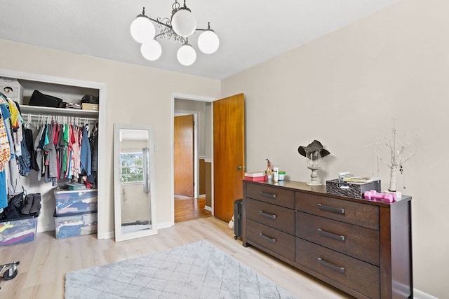 568 N Morris St, Slocomb, AL 36375 - bedroom featuring light wood-style floors, a closet, a chandelier, and baseboards