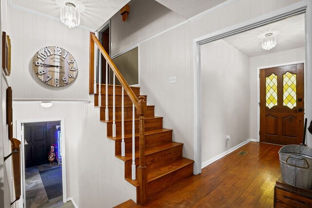 568 N Morris St, Slocomb, AL 36375 - foyer featuring stairs, wood finished floors, ornamental molding, baseboards, and a chandelier