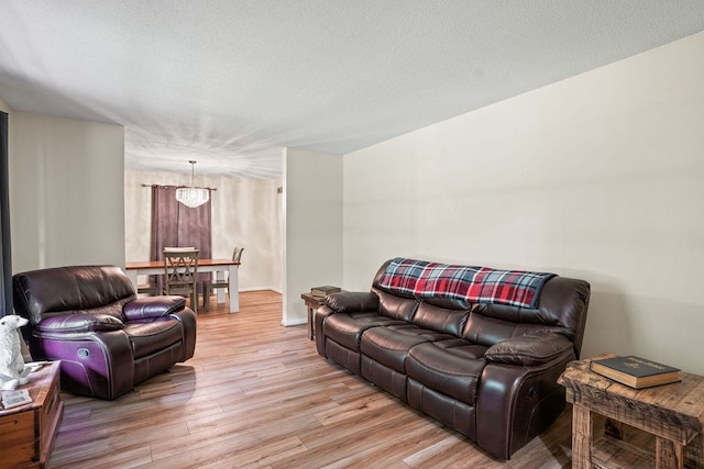 568 N Morris St, Slocomb, AL 36375 - living area featuring light wood-style floors, baseboards, and a textured ceiling