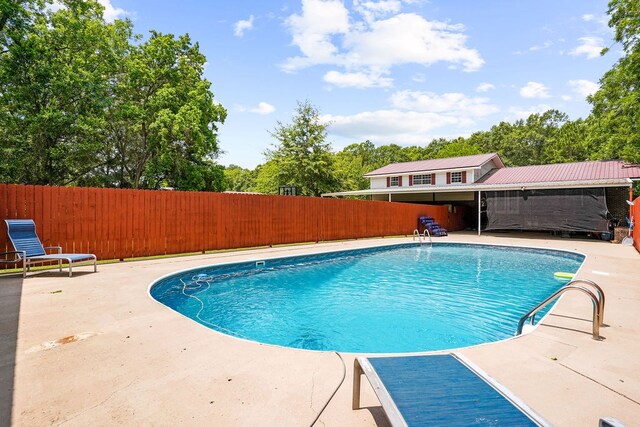568 N Morris St, Slocomb, AL 36375 - view of pool with a patio area, a fenced backyard, and view of wooded area