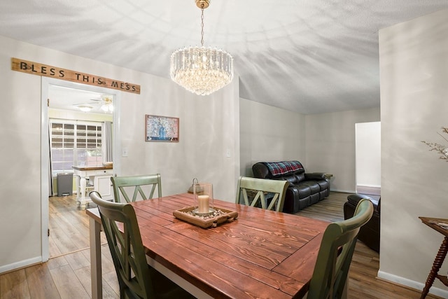 568 N Morris St, Slocomb, AL 36375 - dining room with wood finished floors, a chandelier, baseboards, and a ceiling fan