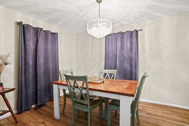 568 N Morris St, Slocomb, AL 36375 - dining space with a chandelier, wood finished floors, and baseboards