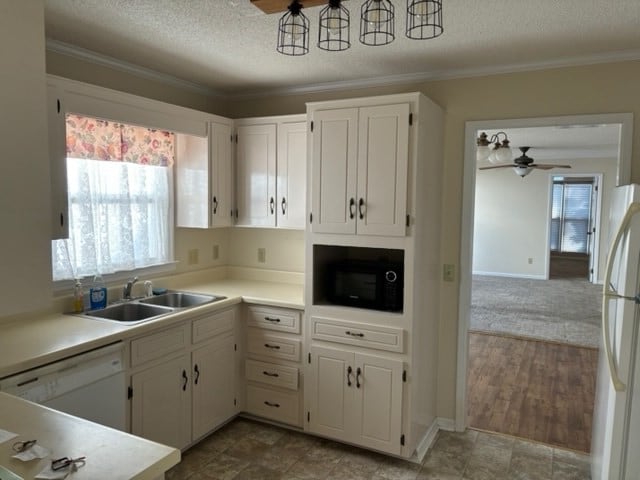 kitchen featuring white cabinetry, sink, a textured ceiling, white appliances, and ornamental molding