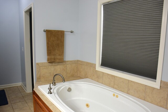 bathroom featuring tile patterned floors and tiled bath