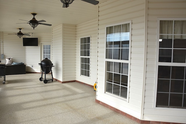 view of patio featuring ceiling fan and a grill