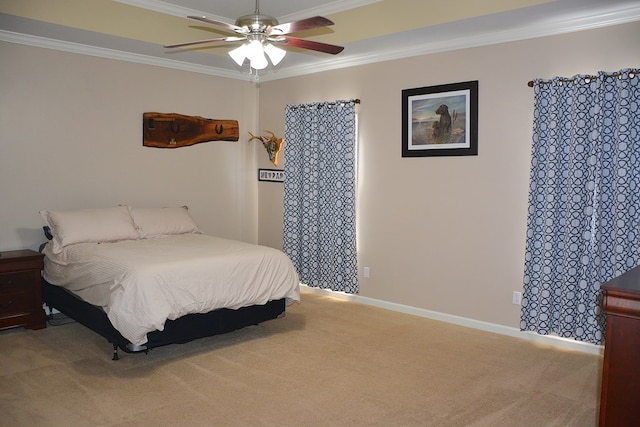 carpeted bedroom with ceiling fan and ornamental molding