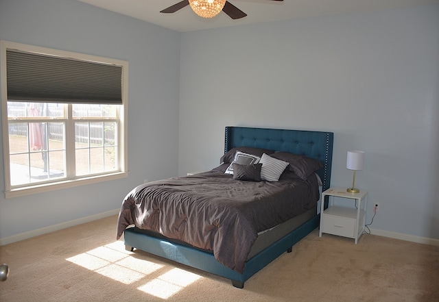 bedroom with light colored carpet and ceiling fan