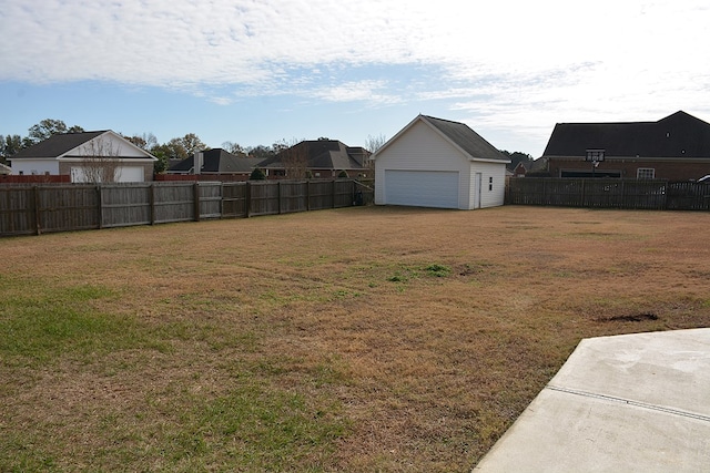 view of yard featuring an outbuilding and a garage