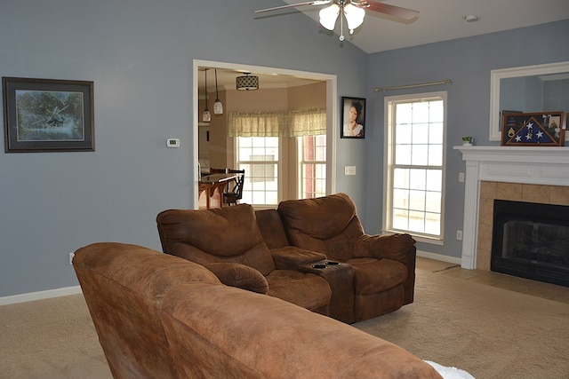 living room with ceiling fan, a tile fireplace, light carpet, and a wealth of natural light