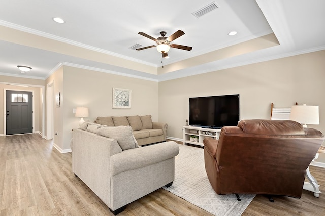 522 Birchwood Ln, Dothan, AL 36301 - living room with light wood-style floors, a ceiling fan, baseboards, crown molding, and a raised ceiling