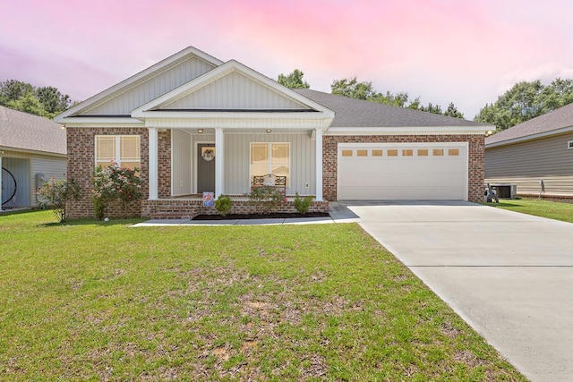 522 Birchwood Ln, Dothan, AL 36301 - view of front of home featuring brick siding, a garage, concrete driveway, a front yard, and central air condition unit