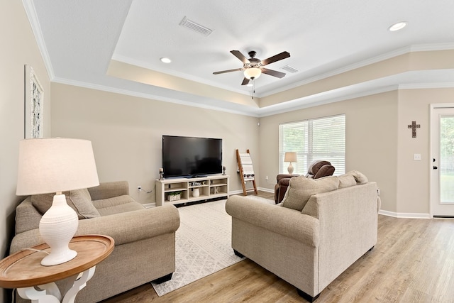 522 Birchwood Ln, Dothan, AL 36301 - living area featuring ceiling fan, light wood-type flooring, crown molding, plenty of natural light, and a raised ceiling