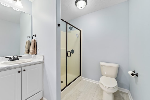 522 Birchwood Ln, Dothan, AL 36301 - bathroom featuring toilet, a stall shower, vanity, baseboards, and a textured ceiling