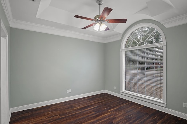 unfurnished room featuring ornamental molding, wood finished floors, and baseboards