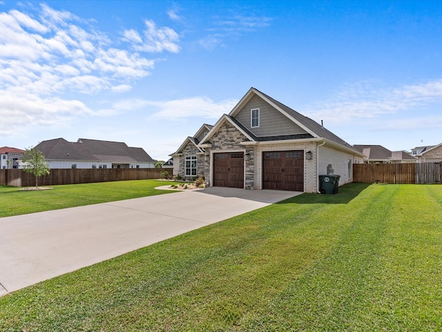 craftsman-style house featuring concrete driveway, stone siding, fence, and a front yard