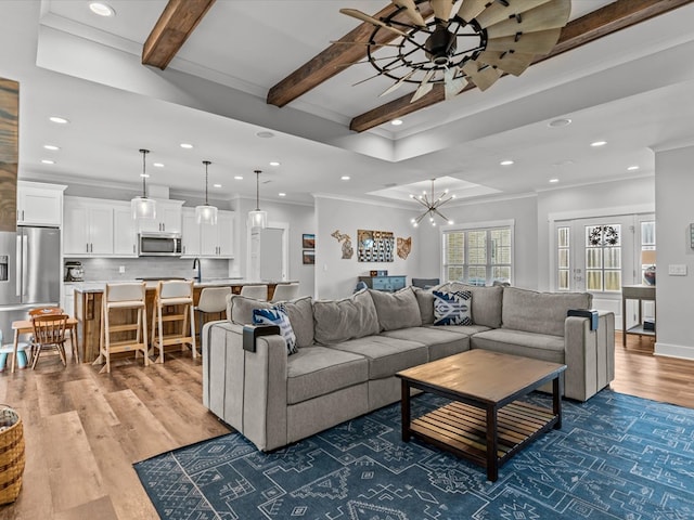 living room featuring recessed lighting, ornamental molding, and ceiling fan with notable chandelier