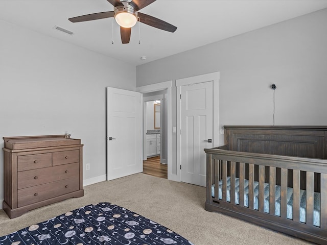 bedroom featuring a ceiling fan, baseboards, visible vents, and carpet
