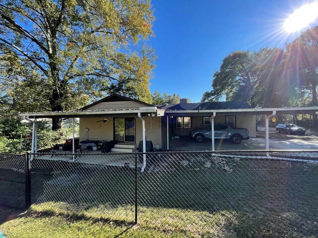 back of house with a carport