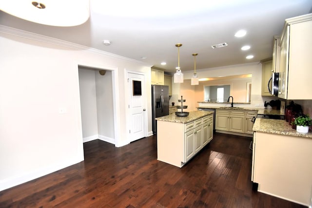 kitchen featuring stainless steel appliances, a kitchen island, sink, light stone counters, and pendant lighting