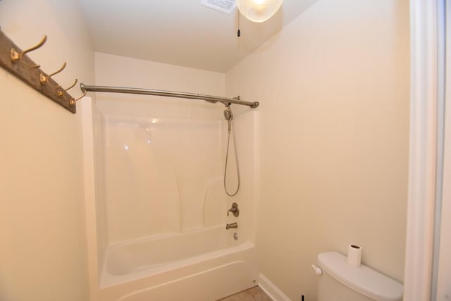 bathroom with bathing tub / shower combination and toilet