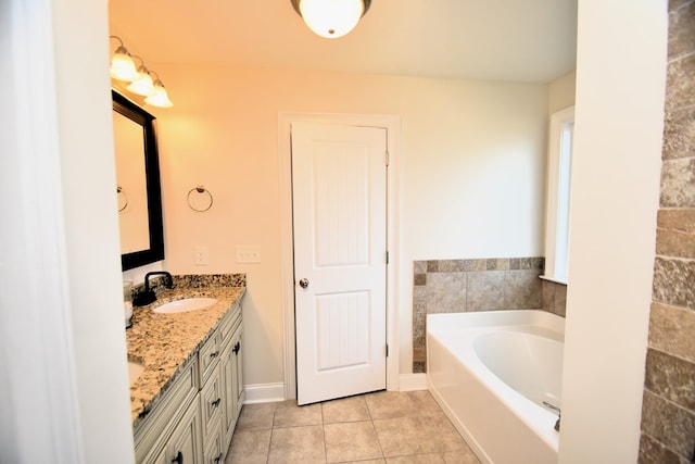 bathroom with vanity, tile patterned flooring, and a bath