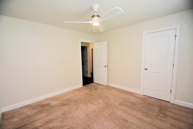 empty room with light colored carpet and ceiling fan