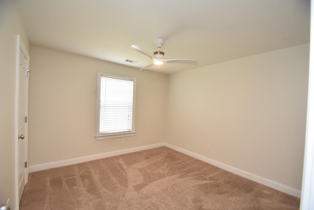 carpeted empty room featuring ceiling fan