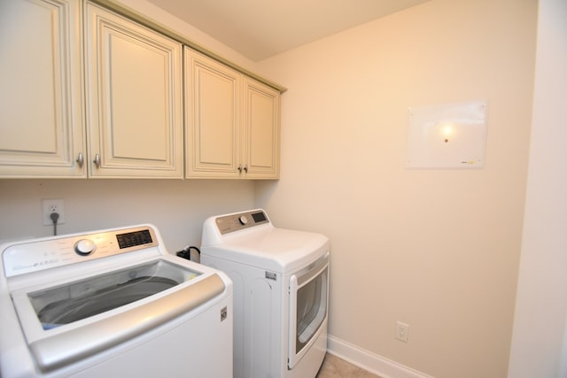 laundry area with cabinets and independent washer and dryer