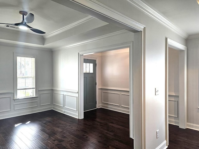 spare room featuring ceiling fan, crown molding, dark hardwood / wood-style flooring, and a raised ceiling