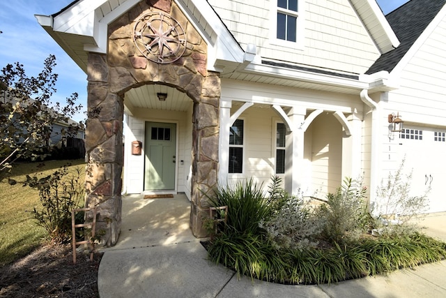 doorway to property with a garage